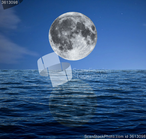 Image of Full moon at night over the sea