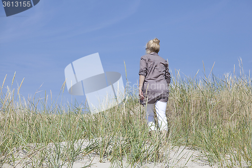 Image of Vacationer walking through dunes