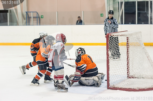 Image of Attack in game between children ice-hockey teams