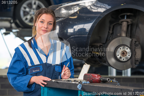 Image of Female mechanic working on a MOT test