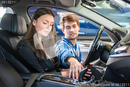 Image of Mechanic demonstrating a second hand car to a potential customer