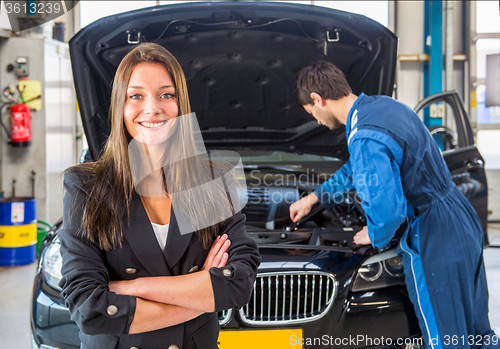 Image of Happy customer, waiting for a mechanic to fix her car