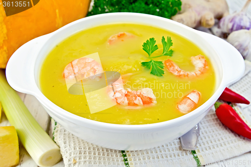 Image of Soup-puree pumpkin with shrimp in white bowl on table