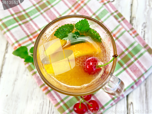Image of Lemonade with cherry in wineglass on board top