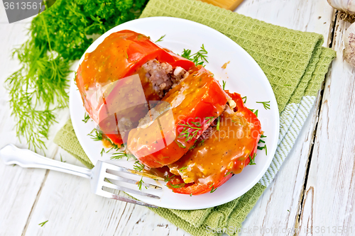 Image of Pepper stuffed meat with sauce in plate on table