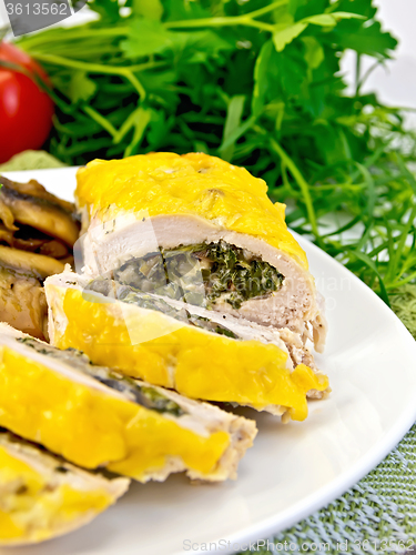 Image of Roll chicken with champignons and spinach on board