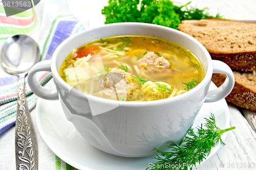 Image of Soup with meatballs and noodles in bowl on saucer