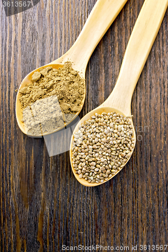 Image of Flour and seed of hemp in wooden spoon on board