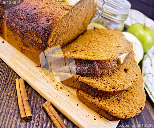 Image of Bread apple with cinnamon on dark board