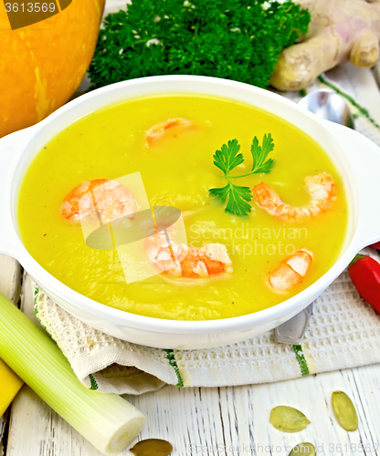 Image of Soup-puree pumpkin with shrimp in white bowl on light board