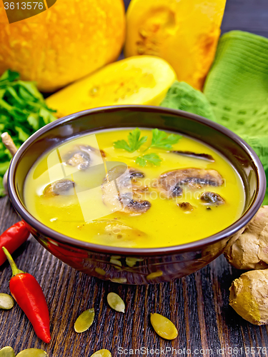 Image of Soup-puree pumpkin with mushrooms on dark board