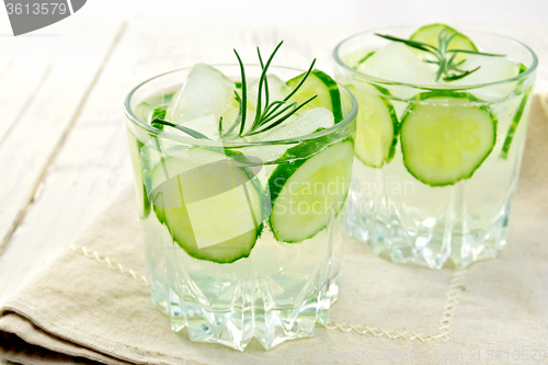 Image of Lemonade with cucumber and rosemary in two glassful on napkin