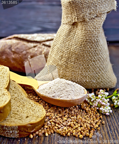 Image of Flour buckwheat in spoon with grains on board