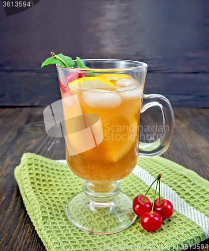 Image of Lemonade with cherry in wineglass on napkin