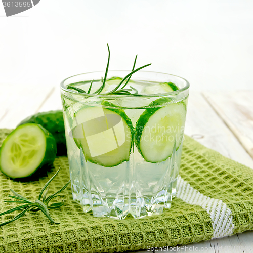Image of Lemonade with cucumber and rosemary in glassful on napkin and bo