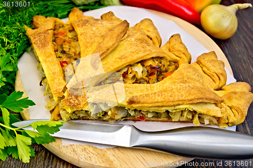 Image of Pie with cabbage and sorrel on board