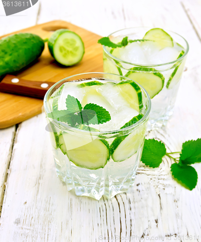 Image of Lemonade with cucumber and mint in two glassful on light board