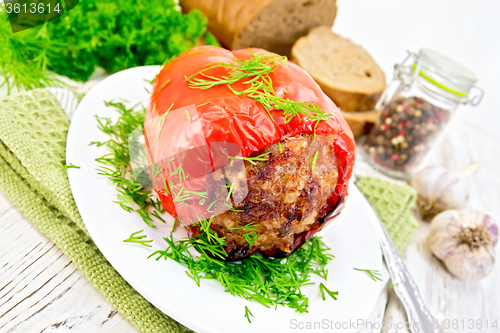 Image of Pepper stuffed meat with dill in plate on table