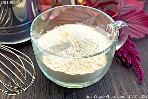 Image of Flour amaranth in glass cup with sieve on board