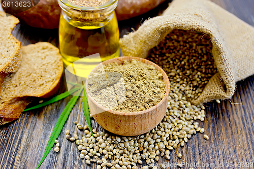 Image of Flour hemp in bowl with bread and oil on board