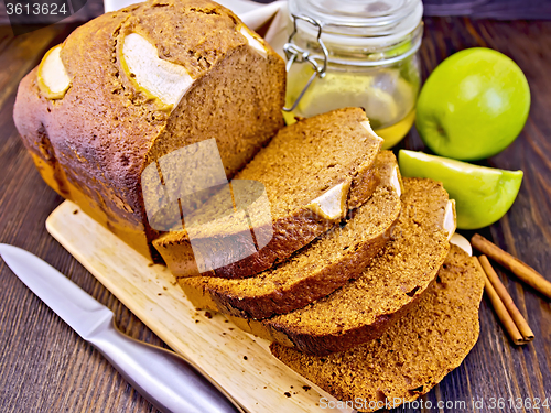 Image of Bread apple with honey on dark board