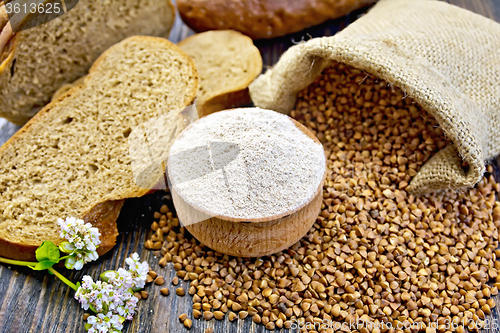 Image of Flour buckwheat in bowl with grains on board