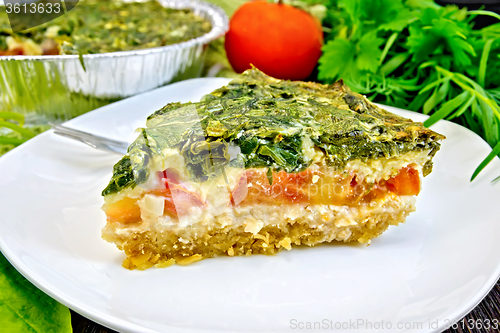 Image of Pie celtic with spinach and tomatoes on board