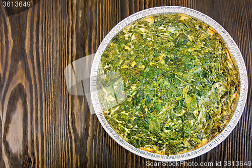 Image of Pie celtic with spinach in form of foil on table