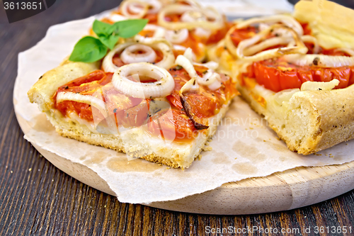 Image of Pie with onions and tomatoes on paper