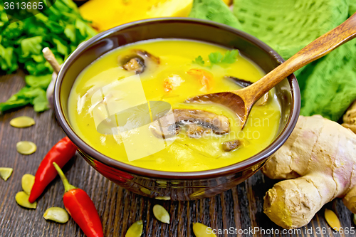 Image of Soup-puree pumpkin with mushrooms and shrimp on dark board