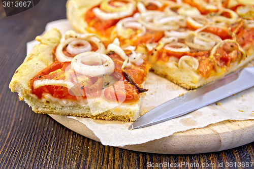 Image of Pie with onions and tomatoes on parchment