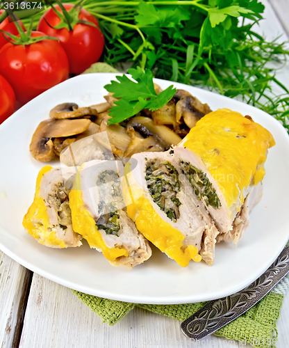 Image of Roll chicken with champignons and cheese on board