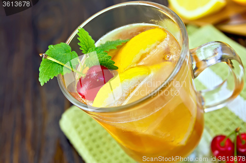 Image of Lemonade with cherry in wineglass on board