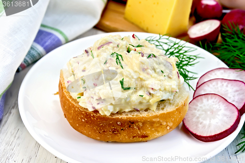 Image of Appetizer of radish and cheese on bun in plate with dill