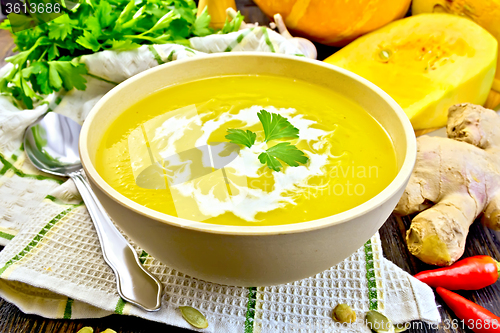 Image of Soup-puree pumpkin with cream in bowl on napkin