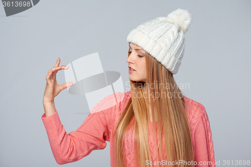 Image of Woman holding imaginary product