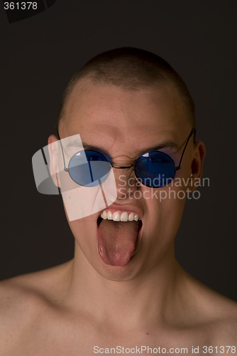 Image of The bald guy shows tongue