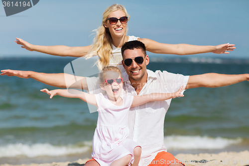 Image of happy family having fun on summer beach