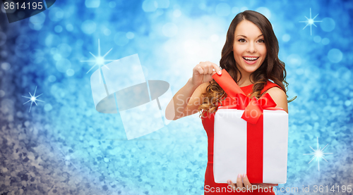 Image of smiling woman in red dress with gift box