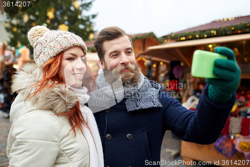 Image of couple taking selfie with smartphone in old town