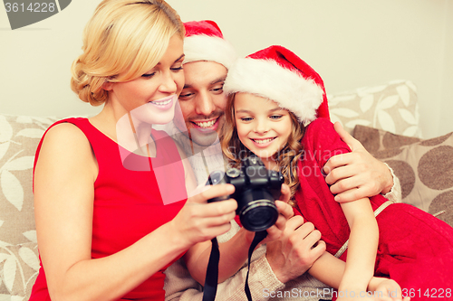 Image of family in santa helper hats looking at pictires