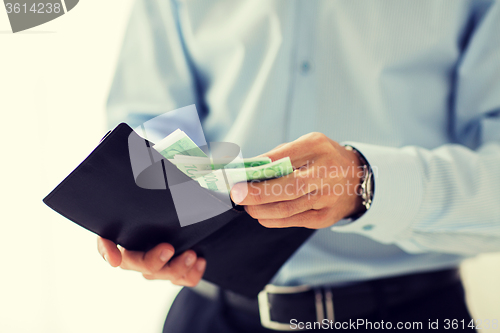 Image of close up of businessman hands holding money