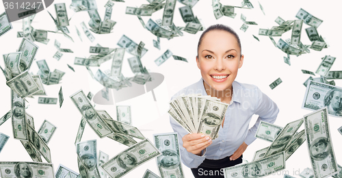 Image of smiling businesswoman with dollar cash money