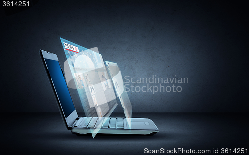 Image of laptop computer with news web page projection