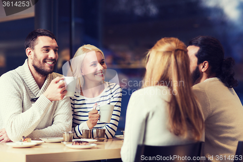 Image of happy friends meeting and drinking tea or coffee