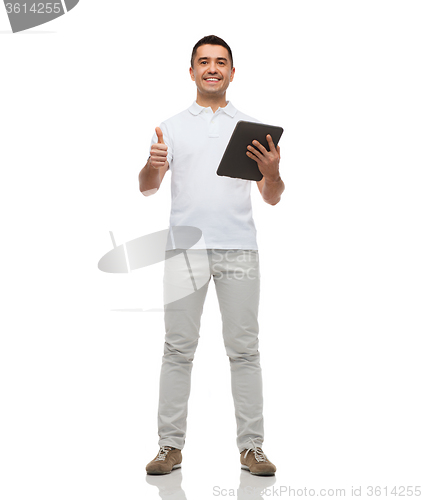 Image of smiling man with tablet pc showing thumbs up