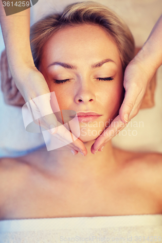 Image of close up of woman having face massage in spa