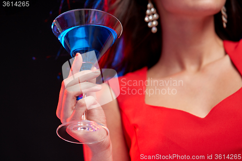 Image of close up of woman with cocktail at nightclub