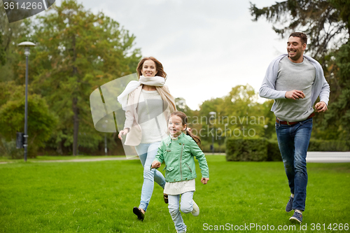 Image of happy family walking in summer park