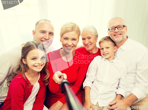 Image of smiling family making selfie at home